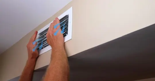 Man checking airflow from the vent